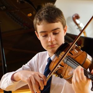 Young student playing violin