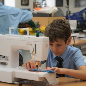 child using a sewing machine