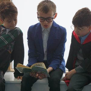 3 boys reading a book