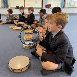 students with drums by their laps