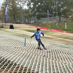 student skiing down a dry slope